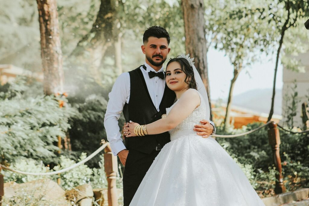 The Bride and Groom Embracing in a Park